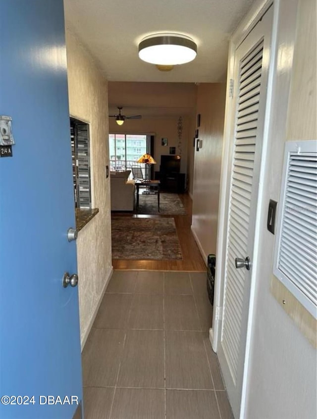 corridor featuring dark tile patterned flooring