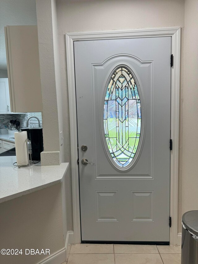 doorway with light tile patterned floors