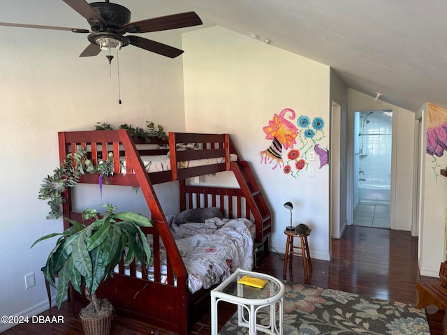 bedroom with ceiling fan, dark hardwood / wood-style flooring, connected bathroom, and vaulted ceiling