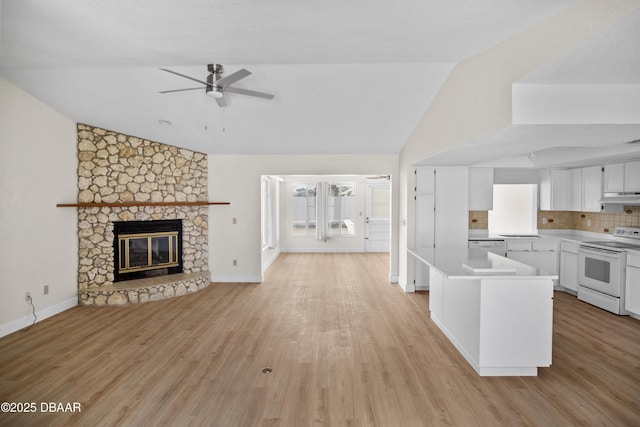 33 Sea Harbor Dr E, Ormond Beach, FL 32176 - kitchen featuring white electric range, under cabinet range hood, open floor plan, healthy amount of natural light, and high vaulted ceiling
