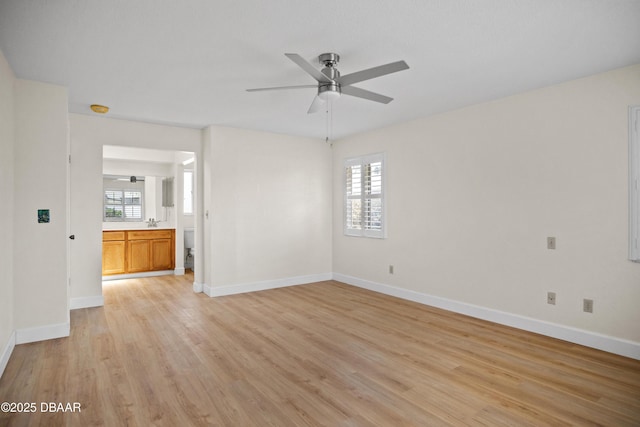 33 Sea Harbor Dr E, Ormond Beach, FL 32176 - unfurnished living room featuring ceiling fan, light wood-type flooring, plenty of natural light, and baseboards