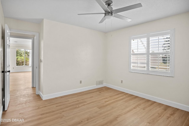 33 Sea Harbor Dr E, Ormond Beach, FL 32176 - empty room with light wood finished floors, baseboards, and ceiling fan