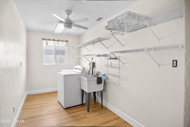 33 Sea Harbor Dr E, Ormond Beach, FL 32176 - laundry room with washer hookup, light wood finished floors, baseboards, and a ceiling fan