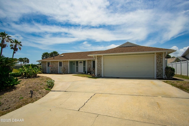 33 Sea Harbor Dr E, Ormond Beach, FL 32176 - ranch-style house with concrete driveway, a garage, fence, and stone siding