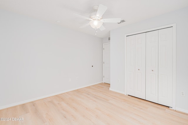 unfurnished bedroom featuring a closet, ceiling fan, and light hardwood / wood-style flooring