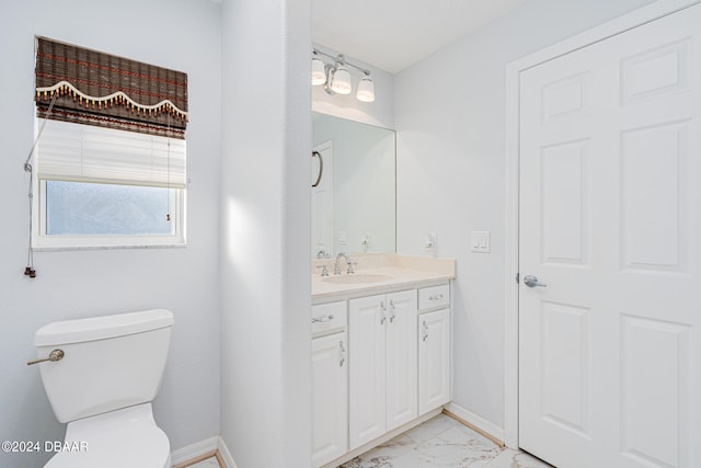 bathroom with toilet and vanity