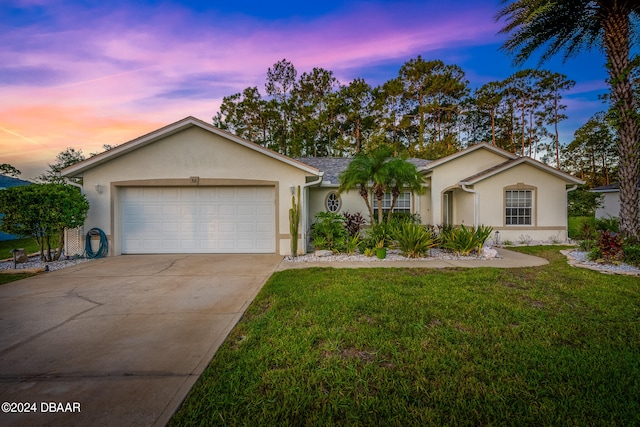 single story home featuring a garage and a yard