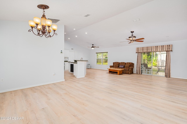 unfurnished living room featuring ceiling fan with notable chandelier, light hardwood / wood-style flooring, and lofted ceiling