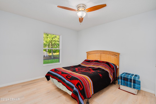 bedroom with hardwood / wood-style floors and ceiling fan