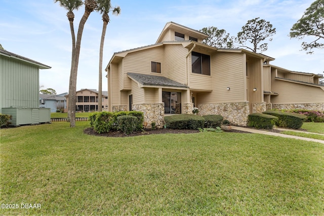 view of front facade featuring stone siding and a front yard