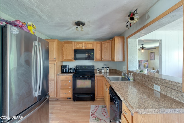 kitchen featuring black appliances, a textured ceiling, sink, ceiling fan, and light hardwood / wood-style flooring