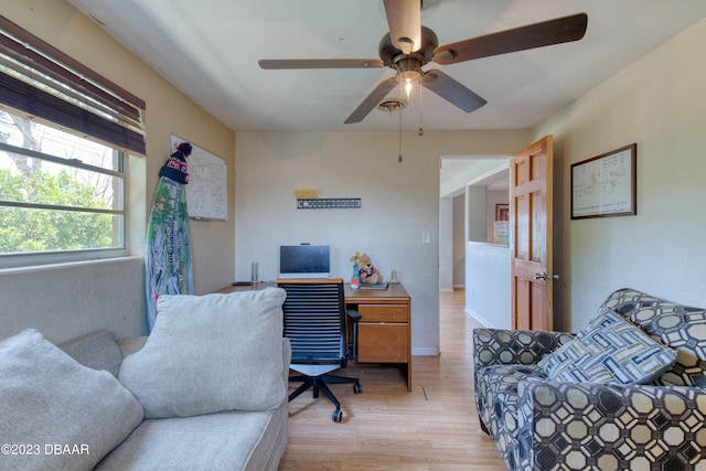 home office featuring light wood-type flooring and ceiling fan