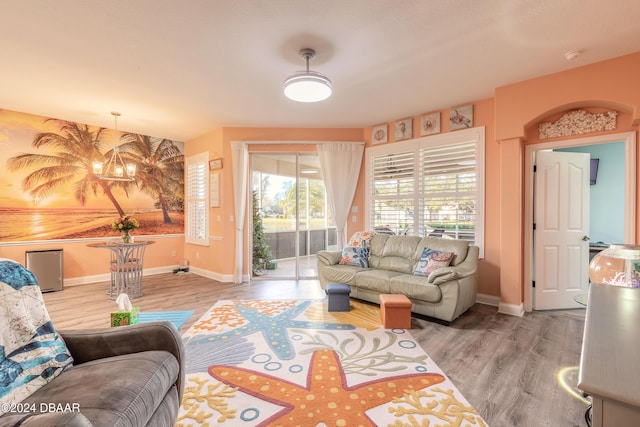 living room with a chandelier and wood-type flooring