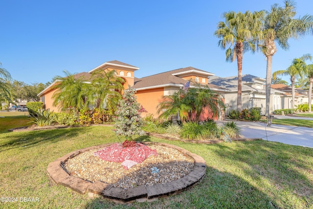 mediterranean / spanish home featuring a front lawn