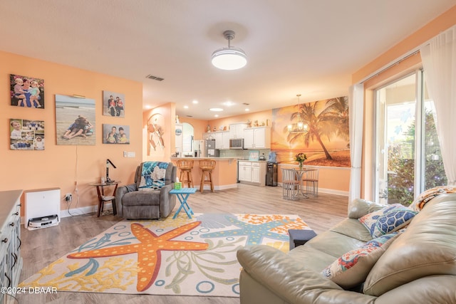 living room with light hardwood / wood-style flooring