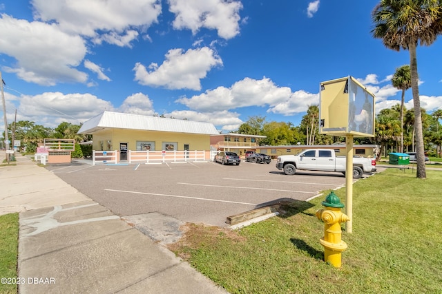 view of parking featuring a lawn