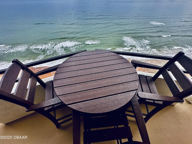 exterior space with a water view and a view of the beach