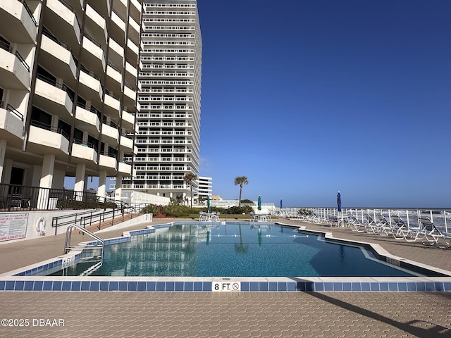 view of swimming pool with a water view