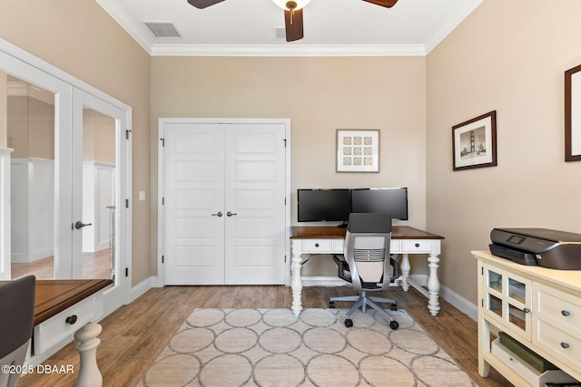 office space with visible vents, wood finished floors, ornamental molding, and ceiling fan