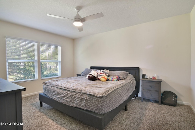 bedroom with ceiling fan, a textured ceiling, and carpet