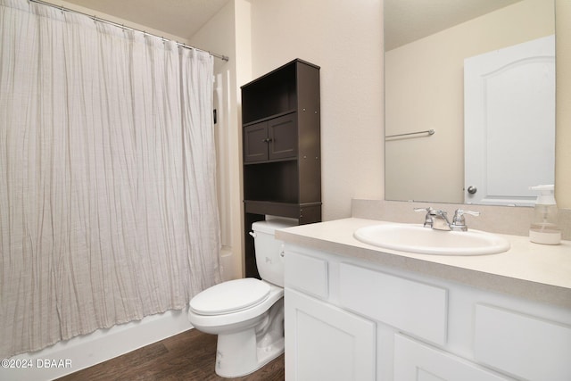 full bathroom with hardwood / wood-style floors, vanity, toilet, and shower / tub combo with curtain