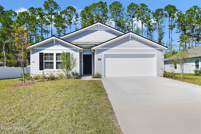 view of front of house featuring a garage and a front yard