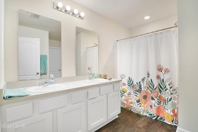 bathroom with vanity, hardwood / wood-style flooring, and a shower with curtain