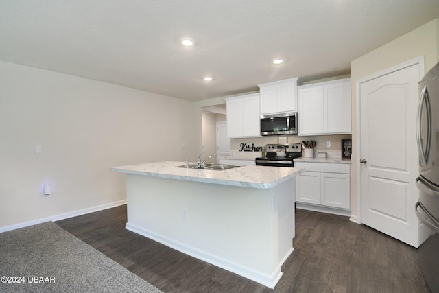 kitchen with white cabinets, sink, an island with sink, dark hardwood / wood-style floors, and appliances with stainless steel finishes