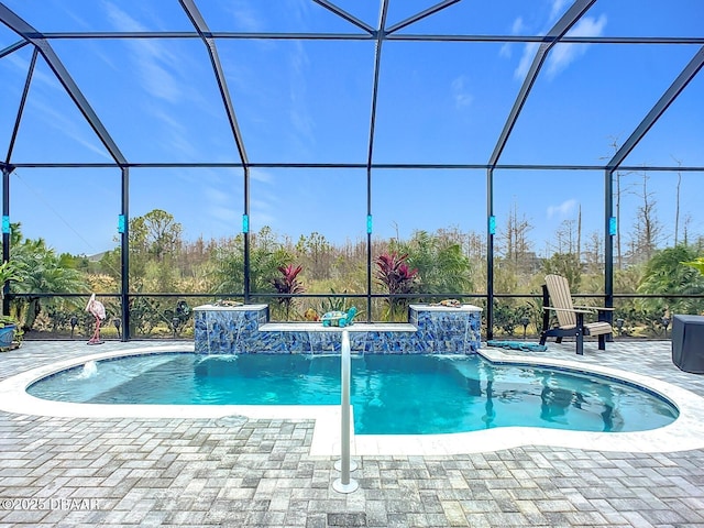 view of swimming pool featuring pool water feature, a patio, and glass enclosure