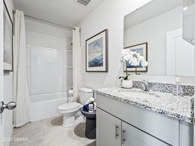 full bathroom featuring vanity, toilet, shower / bath combo, tile patterned floors, and a textured ceiling