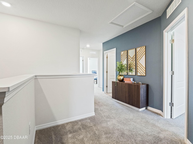 hallway featuring light carpet