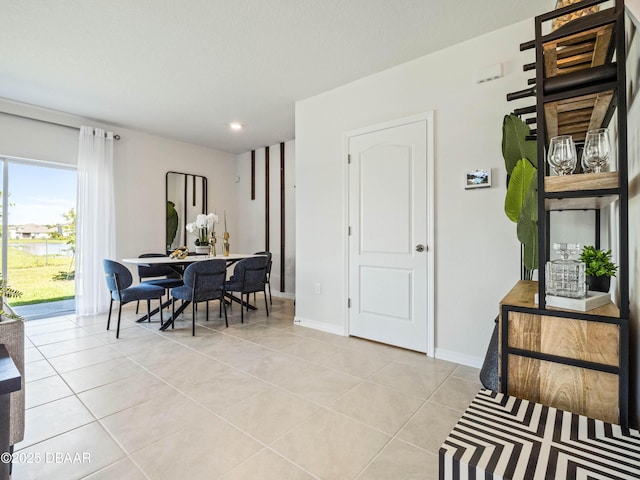 dining space featuring light tile patterned floors