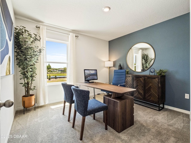 carpeted office space with a textured ceiling