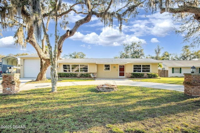 single story home with a detached carport, a front lawn, driveway, and stucco siding