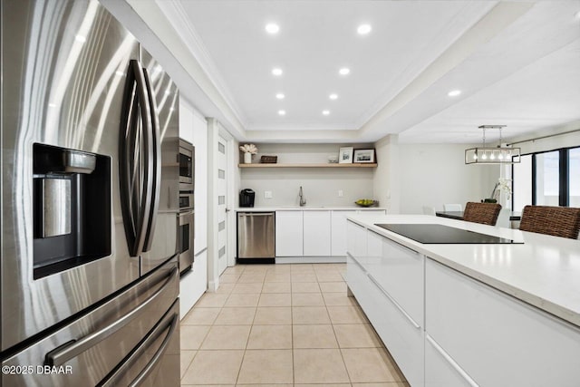 2615 S Atlantic Ave Unit 7H, Daytona Beach, FL 32118 - kitchen featuring appliances with stainless steel finishes, open shelves, light countertops, white cabinets, and ornamental molding