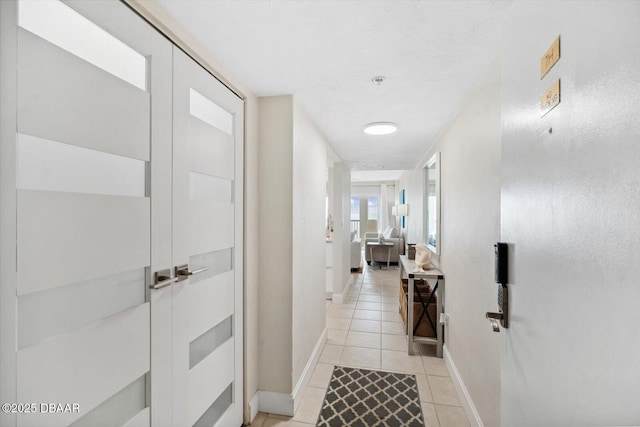 2615 S Atlantic Ave Unit 7H, Daytona Beach, FL 32118 - corridor with light tile patterned flooring and baseboards