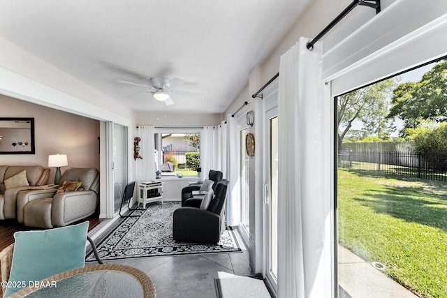 living room with concrete floors and a ceiling fan