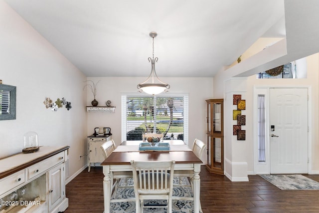 dining area featuring baseboards and dark wood finished floors