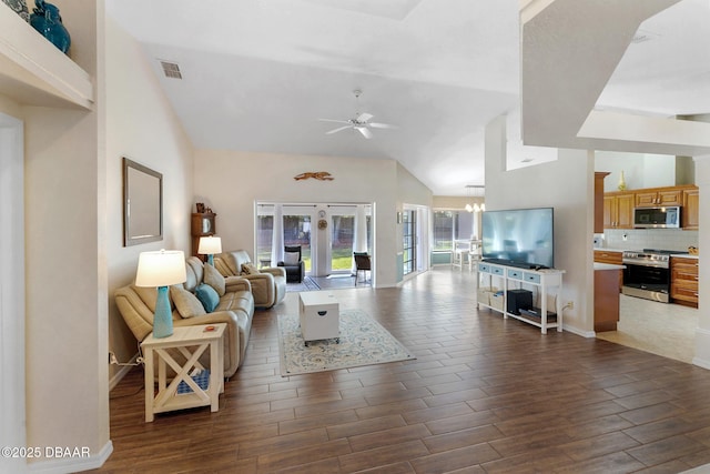 living room with ceiling fan with notable chandelier, baseboards, dark wood-style floors, and visible vents
