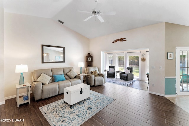 living area with ceiling fan, vaulted ceiling, visible vents, dark wood-style flooring, and baseboards