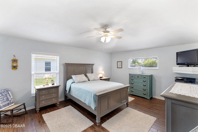 bedroom featuring dark wood-type flooring, ceiling fan, and baseboards