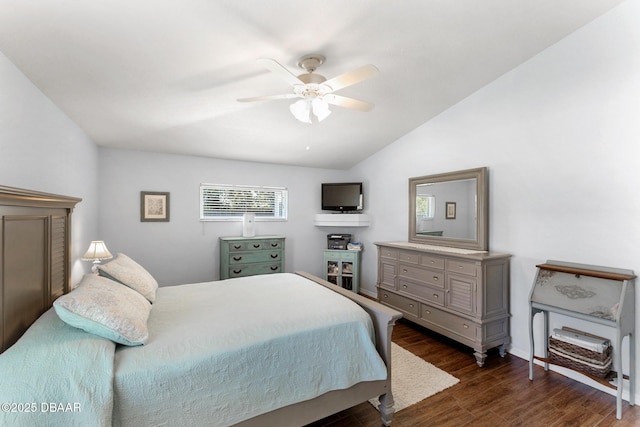 bedroom with dark wood-style flooring, a ceiling fan, and lofted ceiling