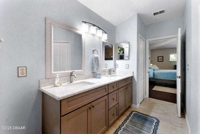 bathroom featuring a sink, visible vents, double vanity, and ensuite bath