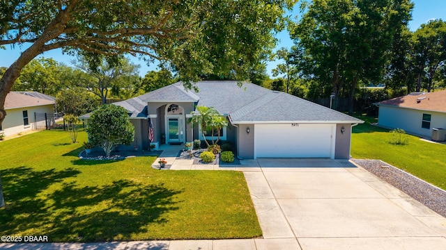 ranch-style house featuring a front yard, an attached garage, stucco siding, driveway, and roof with shingles