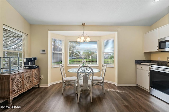 dining room featuring dark hardwood / wood-style floors and a chandelier