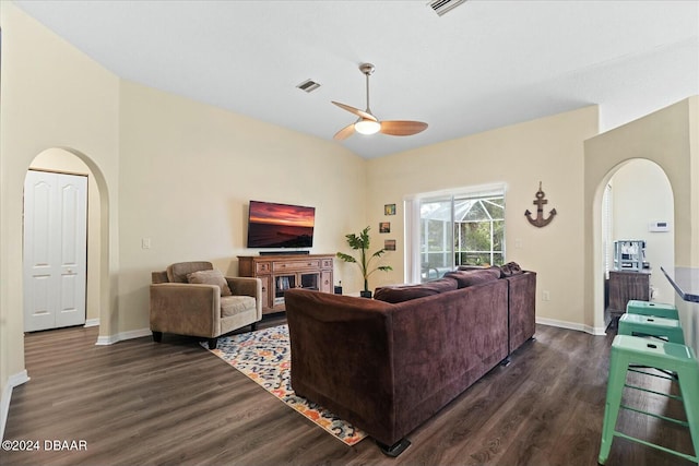 living room with dark hardwood / wood-style floors and ceiling fan