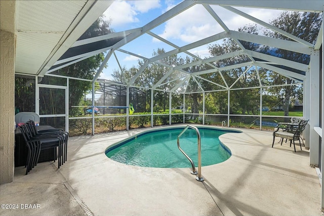 view of swimming pool with a lanai and a patio