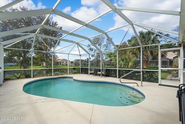 view of swimming pool featuring a patio and glass enclosure