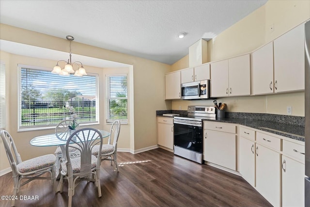 kitchen with white cabinets, pendant lighting, dark hardwood / wood-style floors, and appliances with stainless steel finishes