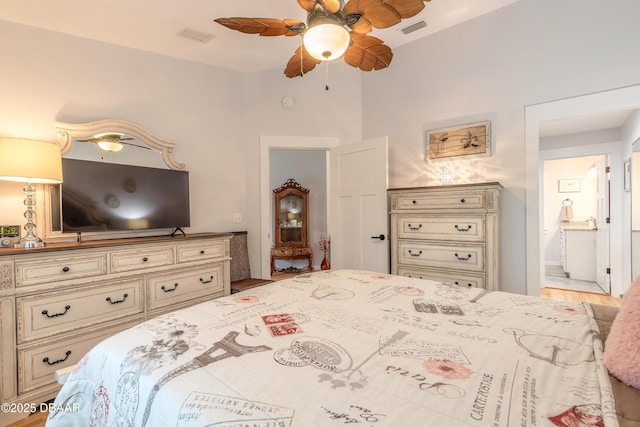 bedroom featuring a ceiling fan, visible vents, and ensuite bath